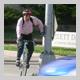 Subject: Biker Commuting to Work; Location: Bike path at John Nolen Drive and Bassett Street, Madison, WI; Date: Summer 2005; Photographer: Carrie Scherpelz